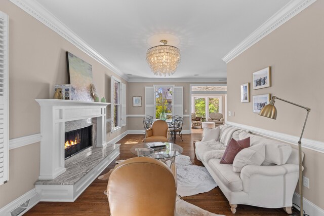 1324 Southlake Dr, Mount Pleasant, SC 29464 - living area featuring a premium fireplace, ornamental molding, visible vents, a notable chandelier, and wood finished floors