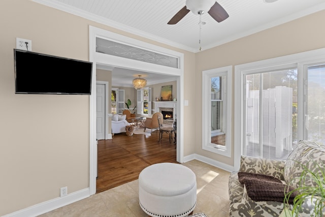 1324 Southlake Dr, Mount Pleasant, SC 29464 - living area featuring a warm lit fireplace, crown molding, light tile patterned floors, baseboards, and a ceiling fan