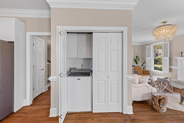1324 Southlake Dr, Mount Pleasant, SC 29464 - interior space with light wood-type flooring, ornamental molding, a chandelier, washer / clothes dryer, and cabinet space