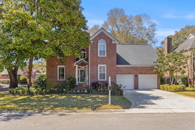 1324 Southlake Dr, Mount Pleasant, SC 29464 - view of front facade with a front yard, concrete driveway, brick siding, a shingled roof, and a garage