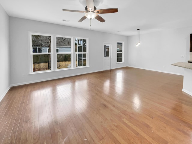 unfurnished living room with ceiling fan and light hardwood / wood-style flooring