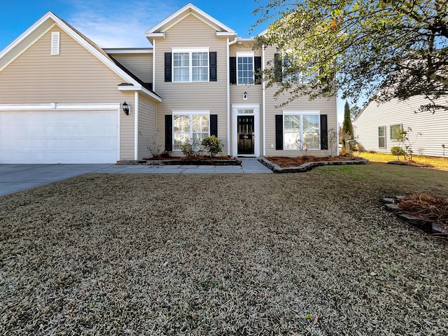 view of front of house with a garage and a front yard