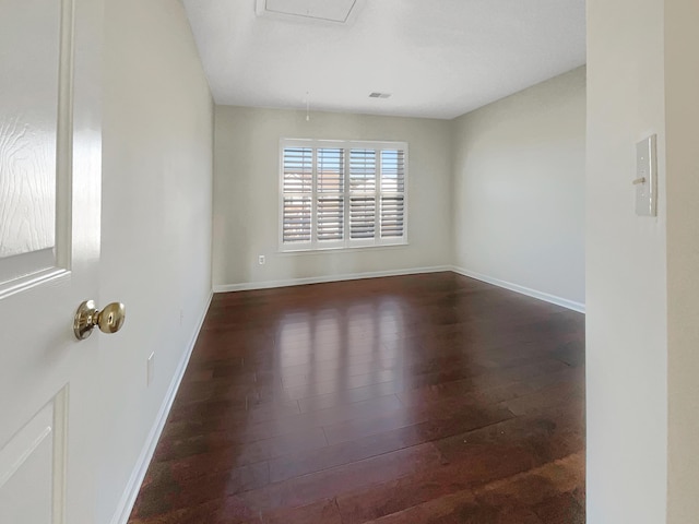 empty room with dark hardwood / wood-style flooring