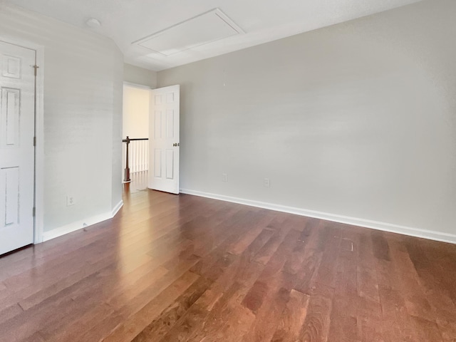 spare room featuring dark wood-type flooring