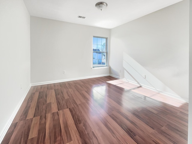 unfurnished room with dark hardwood / wood-style floors