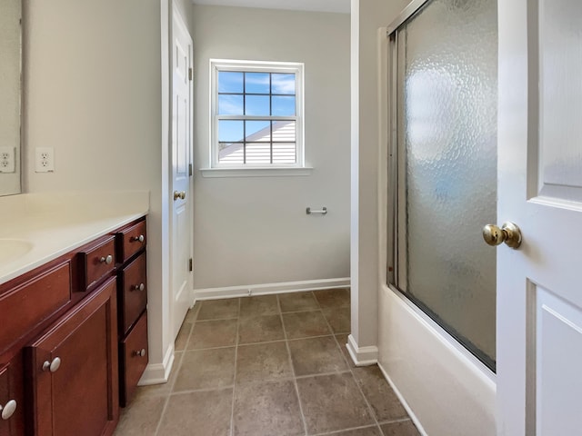 bathroom with bath / shower combo with glass door and vanity