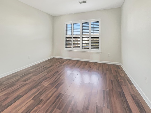 spare room featuring dark hardwood / wood-style flooring