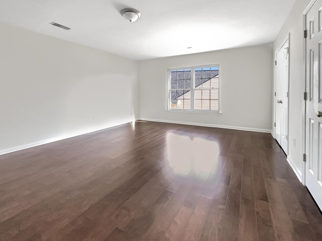 spare room featuring dark hardwood / wood-style floors