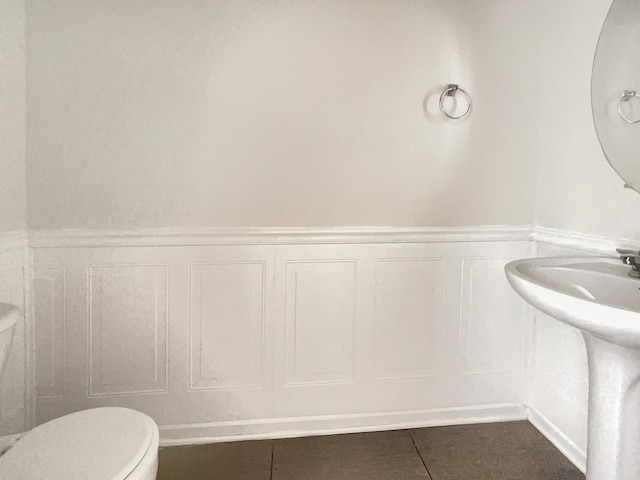 bathroom featuring toilet and tile patterned floors