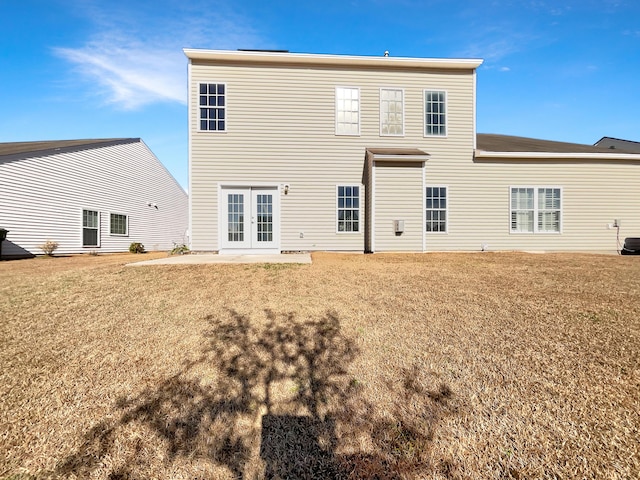 back of house with a patio area and a yard