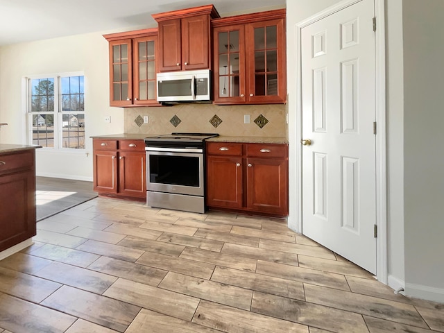 kitchen with appliances with stainless steel finishes and tasteful backsplash