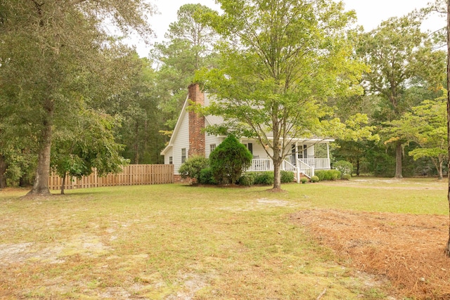 view of yard featuring covered porch