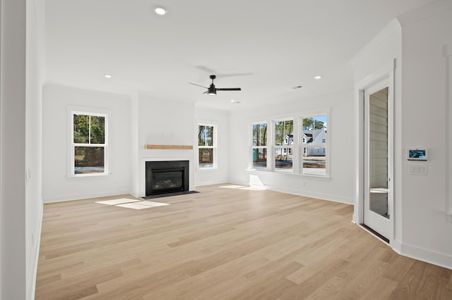 100 E Carolina Ave, Summerville, SC 29483 - unfurnished living room with healthy amount of natural light, ceiling fan, light wood finished floors, a fireplace with flush hearth, and recessed lighting