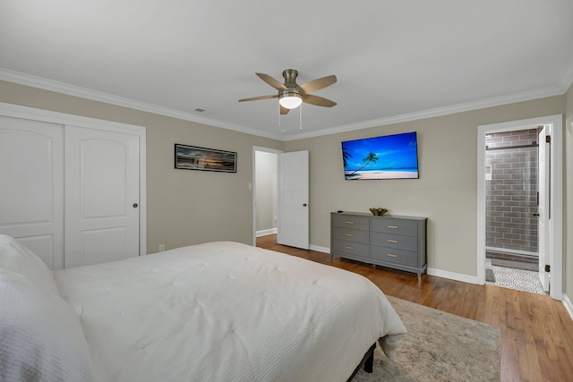 bedroom with ensuite bath, ceiling fan, wood-type flooring, a closet, and ornamental molding