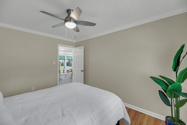 bedroom with light wood-type flooring, ceiling fan, and ornamental molding