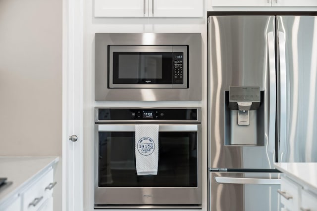 291 Lucca Dr, Summerville, SC 29486 - kitchen with appliances with stainless steel finishes, white cabinetry, and light countertops