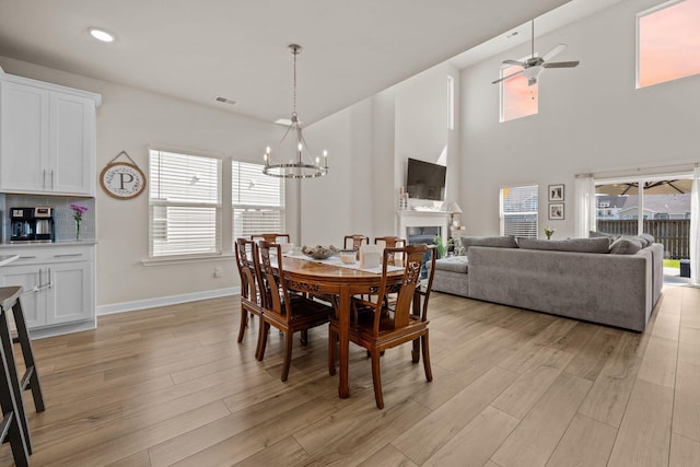 291 Lucca Dr, Summerville, SC 29486 - dining space with a chandelier, a fireplace, light wood-style flooring, a ceiling fan, and recessed lighting