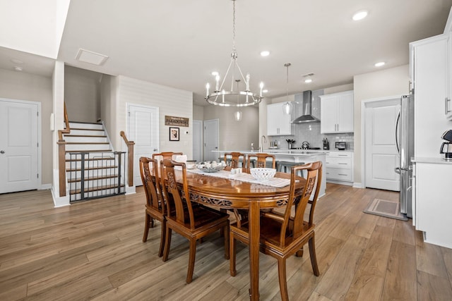 291 Lucca Dr, Summerville, SC 29486 - dining space with a chandelier, recessed lighting, light wood-type flooring, and stairway
