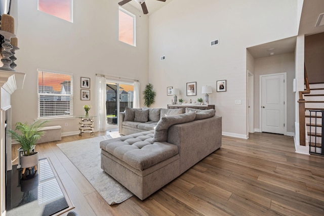 291 Lucca Dr, Summerville, SC 29486 - living room featuring a towering ceiling, ceiling fan, wood finished floors, and stairs