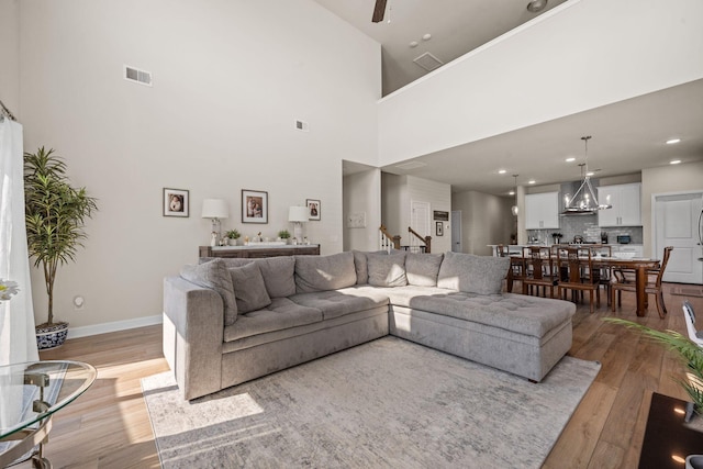 291 Lucca Dr, Summerville, SC 29486 - living area featuring light wood-style flooring, stairs, a high ceiling, and recessed lighting