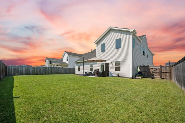 291 Lucca Dr, Summerville, SC 29486 - back of house at dusk with a fenced backyard and a patio