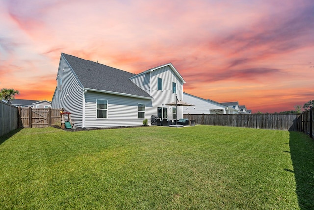 291 Lucca Dr, Summerville, SC 29486 - back of house at dusk featuring roof with shingles, a fenced backyard, an outdoor living space, and a patio
