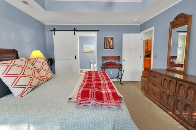 bedroom with a tray ceiling, crown molding, carpet floors, and a barn door