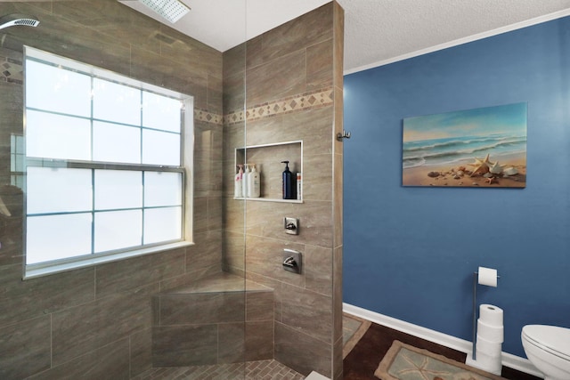 bathroom featuring toilet and tiled shower