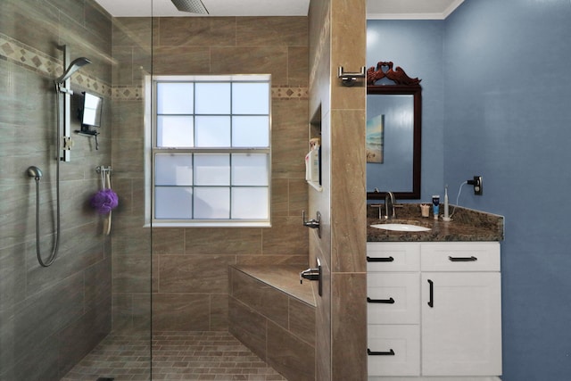 bathroom with vanity and a shower with door