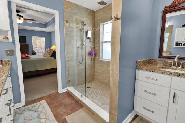 bathroom with ceiling fan, tiled shower, and vanity