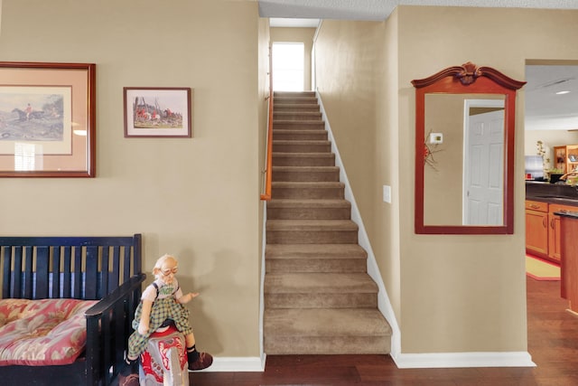 stairs featuring sink and hardwood / wood-style floors