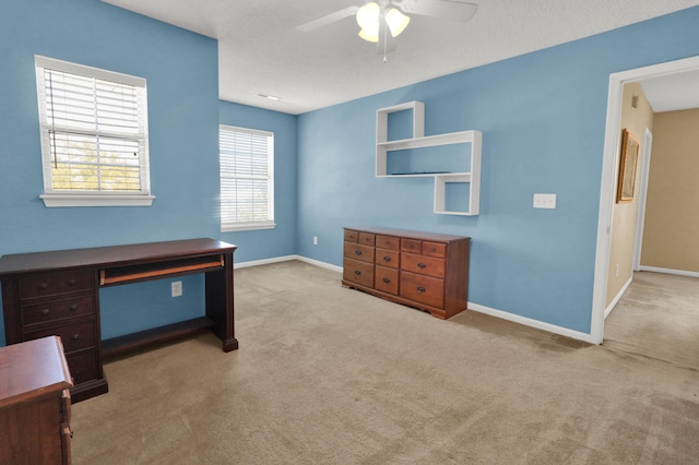 unfurnished office with light colored carpet and ceiling fan