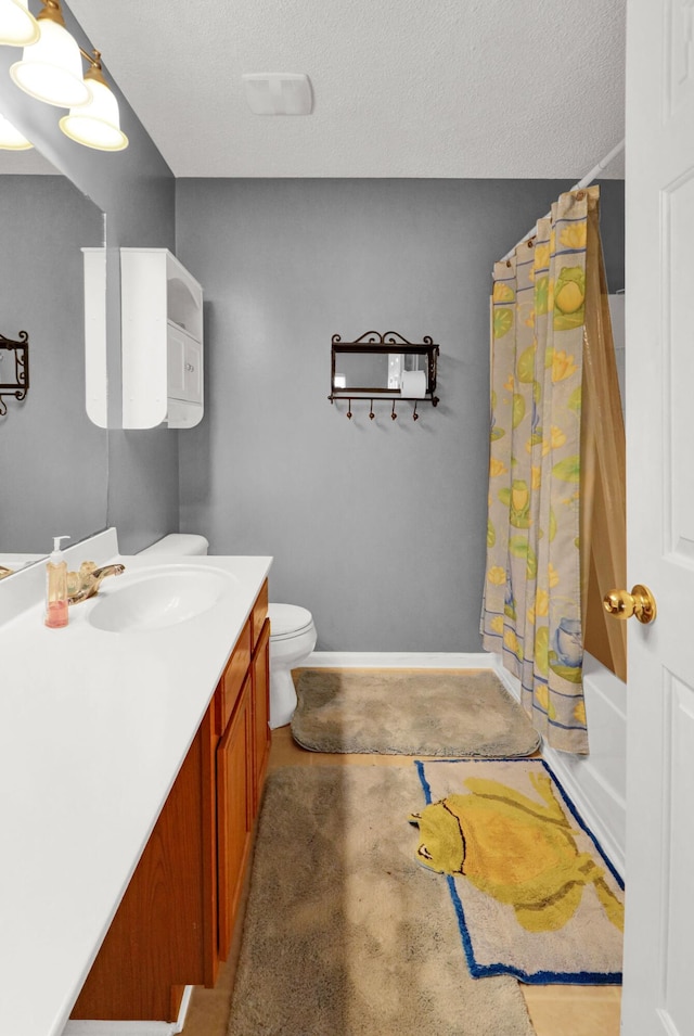 full bathroom featuring vanity, shower / bath combo, a textured ceiling, and toilet