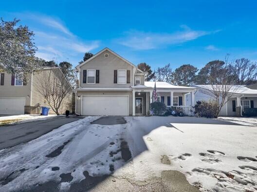 front of property featuring a garage and covered porch