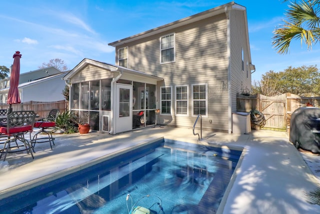 back of property with a patio and a sunroom