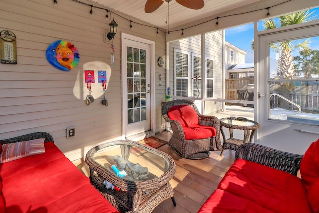 sunroom featuring ceiling fan and rail lighting