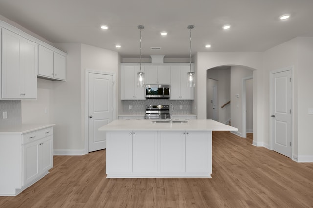 139 Dantzler Rd, Harleyville, SC 29448 - kitchen featuring a sink, appliances with stainless steel finishes, light countertops, baseboards, and arched walkways