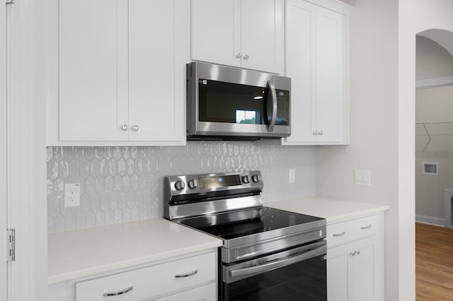 139 Dantzler Rd, Harleyville, SC 29448 - kitchen with white cabinetry, stainless steel appliances, backsplash, and light countertops