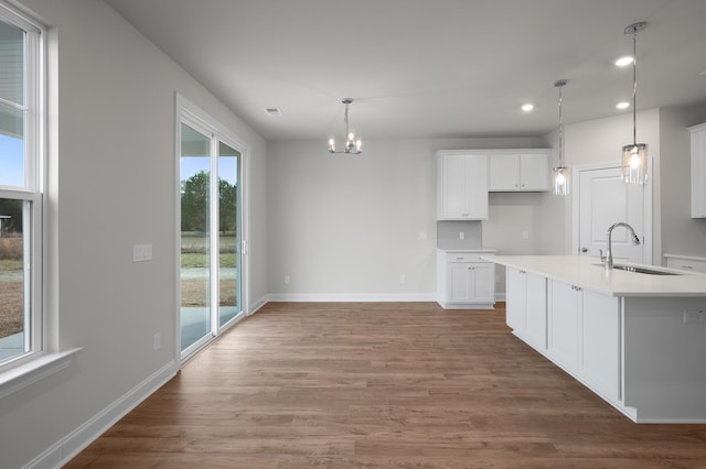 139 Dantzler Rd, Harleyville, SC 29448 - kitchen with recessed lighting, a sink, a chandelier, white cabinetry, and wood finished floors