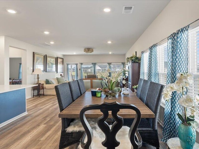 dining area featuring plenty of natural light and light hardwood / wood-style flooring