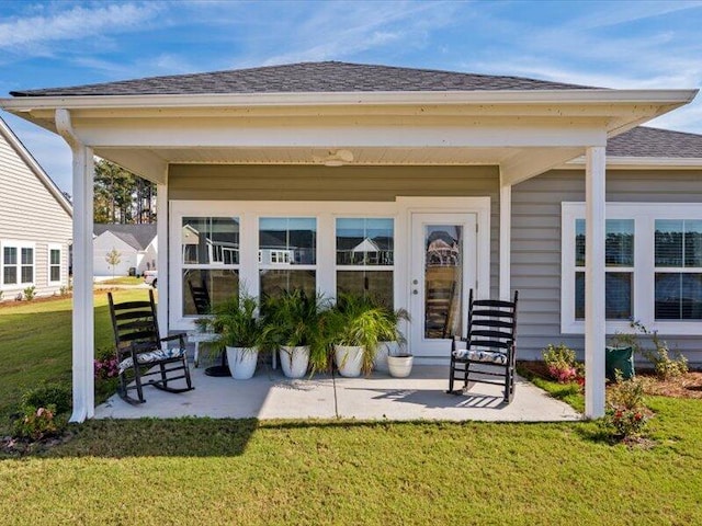 rear view of house featuring a patio and a lawn