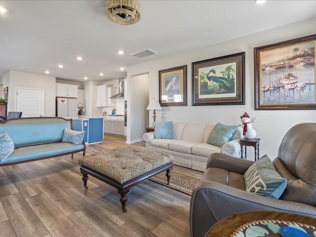 living room with hardwood / wood-style floors and sink