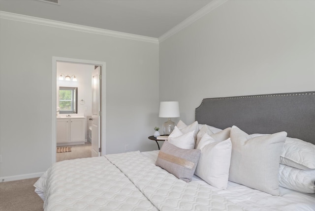 bedroom featuring ensuite bathroom, crown molding, and light colored carpet