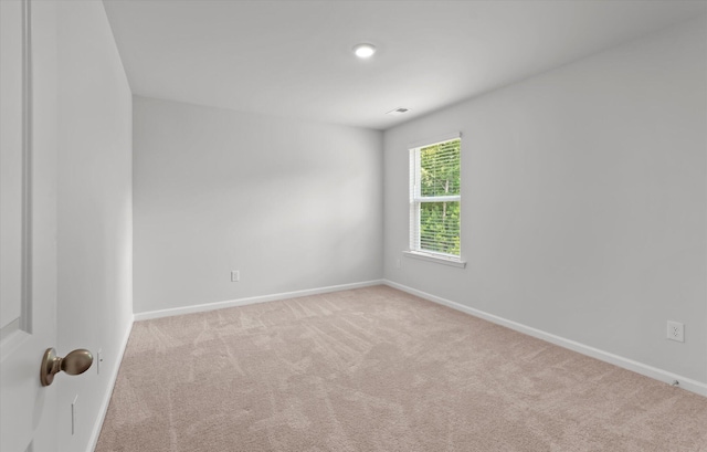 spare room with light colored carpet