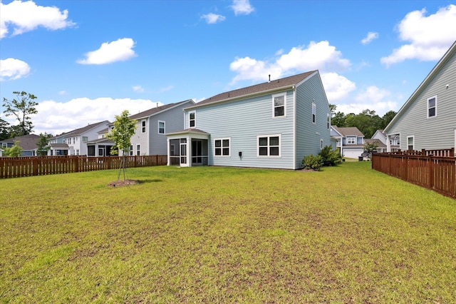 back of house featuring a yard