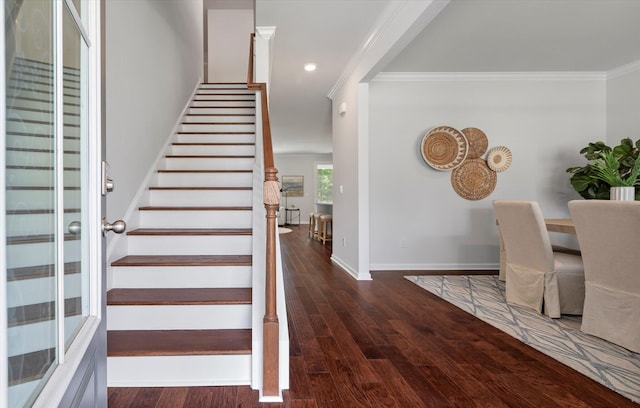 stairs featuring wood-type flooring and crown molding