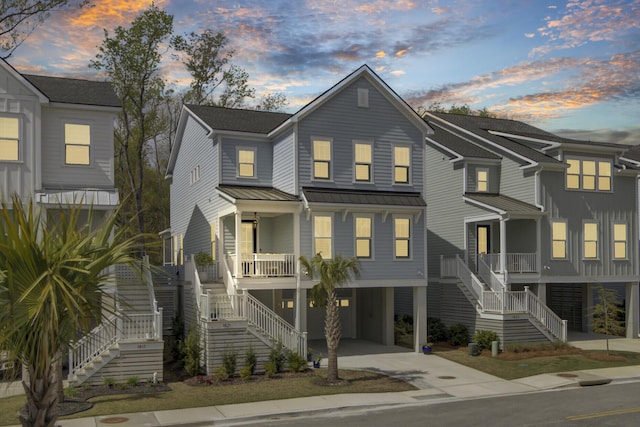 1821 Mead Ln, Johns Island, SC 29455 - view of front facade with stairs, covered porch, a carport, a standing seam roof, and driveway