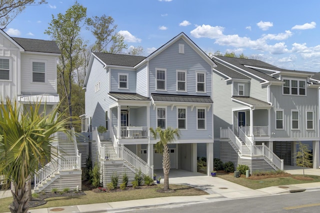 1821 Mead Ln, Johns Island, SC 29455 - coastal inspired home featuring stairway, a carport, a porch, a standing seam roof, and driveway