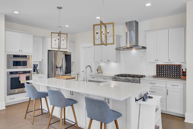 1821 Mead Ln, Johns Island, SC 29455 - kitchen featuring wall chimney range hood, stainless steel appliances, a sink, decorative backsplash, and white cabinets