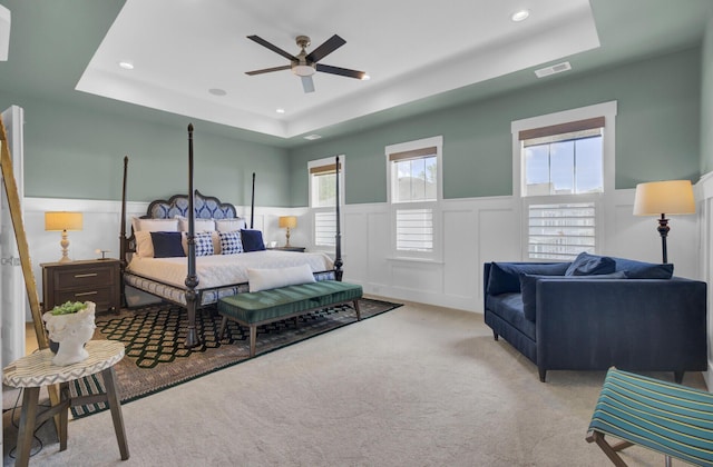 1821 Mead Ln, Johns Island, SC 29455 - carpeted bedroom featuring a tray ceiling, a decorative wall, a wainscoted wall, and recessed lighting